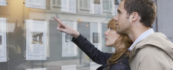 couple looking at listings to buy real estate